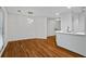Open-concept living room with hardwood floors, modern lighting, and a view of the kitchen bar at 1250 Parkwood Se Cir # 3101, Atlanta, GA 30339