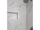 Modern shower featuring white marble walls, a niche, and stylish fixtures at 1250 Parkwood Se Cir # 3101, Atlanta, GA 30339