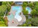 Stunning aerial view showcasing a multi-pool aquatic center with water slide and clubhouse surrounded by lush green landscaping at 162 Greenbrier Way, Canton, GA 30114