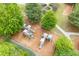Aerial view showcases the community playground with slides and play structures surrounded by mature trees and landscaping at 162 Greenbrier Way, Canton, GA 30114