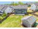 Aerial shot of a spacious backyard featuring a two-story home, a shed, and lush greenery in a residential area at 162 Greenbrier Way, Canton, GA 30114