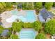 Aerial image highlighting the multiple pools, waterslide, landscaping, and clubhouse amenities within the community at 162 Greenbrier Way, Canton, GA 30114