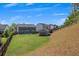 A large backyard showing a two-story home with a patio, shed, and lush green lawn, perfect for outdoor enjoyment at 162 Greenbrier Way, Canton, GA 30114
