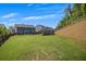 Expansive backyard with a two-story home, a shed, and a gently sloping hill, creating a picturesque setting at 162 Greenbrier Way, Canton, GA 30114