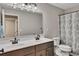 Bathroom featuring a double sink vanity with a shower-tub combination at 162 Greenbrier Way, Canton, GA 30114