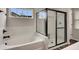 Bathroom featuring soaking tub and tiled glass shower at 162 Greenbrier Way, Canton, GA 30114