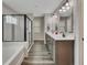 Bathroom featuring double sink vanity, tub, and tiled glass shower at 162 Greenbrier Way, Canton, GA 30114
