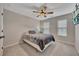 Comfortable bedroom with ceiling fan, wall mounted TV, and window at 162 Greenbrier Way, Canton, GA 30114