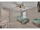 Cozy bedroom with ceiling fan, desk, and comfy beanbag chair at 162 Greenbrier Way, Canton, GA 30114