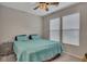 Cozy bedroom with a ceiling fan, two windows, and carpeted floor at 162 Greenbrier Way, Canton, GA 30114