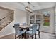 Dining room with modern light fixture, staircase, and lots of natural light at 162 Greenbrier Way, Canton, GA 30114