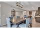 Open-concept dining room with modern light fixture, flowing into the kitchen with dark cabinetry and white countertops at 162 Greenbrier Way, Canton, GA 30114
