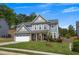 Charming two-story home with a well-manicured lawn, gray siding, and stone accents on the front porch columns at 162 Greenbrier Way, Canton, GA 30114