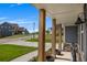 View from the front porch of a neighborhood street with well-maintained lawns and similar homes at 162 Greenbrier Way, Canton, GA 30114