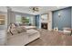 Comfortable living room with a fireplace, large windows, and a plush sectional couch at 162 Greenbrier Way, Canton, GA 30114