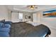 Spacious main bedroom featuring tray ceilings, ceiling fan, barn door to bathroom, and wall mounted TV at 162 Greenbrier Way, Canton, GA 30114