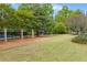 Community playground featuring swings, playhouse, and lush green space for outdoor fun and recreation at 162 Greenbrier Way, Canton, GA 30114