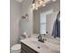 Cozy powder room with a marble countertop, decorative shelf, and modern lighting fixtures at 162 Greenbrier Way, Canton, GA 30114