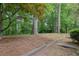 Backyard featuring mature trees and natural setting at 25 Ivy Gates Ne, Atlanta, GA 30342