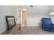 Bedroom featuring a comfortable blue chair and an doorway leading to the en-suite bathroom at 25 Ivy Gates Ne, Atlanta, GA 30342