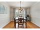 Dining room featuring hardwood floors, modern light fixture, and a beverage cooler at 25 Ivy Gates Ne, Atlanta, GA 30342
