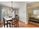 Dining area with hardwood floors, natural light, modern light fixture, and open access to the entryway at 25 Ivy Gates Ne, Atlanta, GA 30342