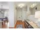Welcoming entryway with hardwood floors, decorative mirror, console table, and access to dining area at 25 Ivy Gates Ne, Atlanta, GA 30342