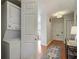 Hallway featuring a stackable washer and dryer, wood flooring, and neutral colored walls at 25 Ivy Gates Ne, Atlanta, GA 30342