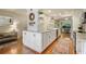 Bright kitchen featuring white cabinets, stainless steel appliances, marble countertops, and hardwood floors at 25 Ivy Gates Ne, Atlanta, GA 30342