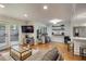 Open-concept living room with hardwood floors, comfortable seating, and a view of the office at 25 Ivy Gates Ne, Atlanta, GA 30342