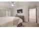 Serene main bedroom featuring a ceiling fan, plantation shutters, and a decorative dresser at 25 Ivy Gates Ne, Atlanta, GA 30342