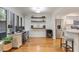 Office space with natural light, hardwood floors, a modern desk setup, and access to the kitchen at 25 Ivy Gates Ne, Atlanta, GA 30342