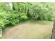 Large grassy backyard surrounded by lush trees in this serene setting at 4065 Maxanne Nw Dr, Kennesaw, GA 30144