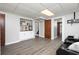 Finished basement featuring laminate flooring, three black recliner chairs, and a kitchenette with white cabinets at 4065 Maxanne Nw Dr, Kennesaw, GA 30144