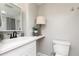Neutrally decorated bathroom featuring a white sink, toilet, and modern lighting at 4065 Maxanne Nw Dr, Kennesaw, GA 30144
