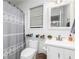 Bright bathroom featuring tile flooring, a sink with white vanity, a matching framed mirror, toilet, and shower at 4065 Maxanne Nw Dr, Kennesaw, GA 30144