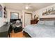 Bedroom featuring laminate flooring, a ceiling fan, a window, and a desk with multiple monitors and shelving at 4065 Maxanne Nw Dr, Kennesaw, GA 30144