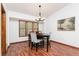 Elegant dining room with hardwood floors, large windows, and a stylish chandelier at 4065 Maxanne Nw Dr, Kennesaw, GA 30144