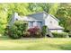 Charming gray home with lush landscaping and a welcoming front porch surrounded by mature trees at 4065 Maxanne Nw Dr, Kennesaw, GA 30144