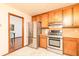 Functional kitchen with stainless steel appliances and wood cabinetry, located next to dining area at 4065 Maxanne Nw Dr, Kennesaw, GA 30144