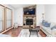 Cozy living room with a stone fireplace, wood floors, and natural light from large windows at 4065 Maxanne Nw Dr, Kennesaw, GA 30144