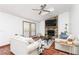 Bright living room with vaulted ceilings, a ceiling fan, a stone fireplace, and hardwood floors at 4065 Maxanne Nw Dr, Kennesaw, GA 30144