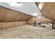 Large unfinished attic space with neutral carpet and wood paneling, providing ample room for storage or hobbies at 4702 Sequoia Sw Dr, Lilburn, GA 30047