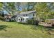 View of the home's backyard showing an expansive lawn, patio, and greenery at 4702 Sequoia Sw Dr, Lilburn, GA 30047
