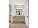 Bright bathroom with double sink vanity, framed mirrors, and updated fixtures at 4702 Sequoia Sw Dr, Lilburn, GA 30047