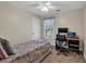 Cozy bedroom featuring a paisley bedspread, ceiling fan, desk and chair at 4702 Sequoia Sw Dr, Lilburn, GA 30047