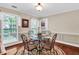 Cozy dining area featuring a round glass table, elegant chairs, and warm lighting at 4702 Sequoia Sw Dr, Lilburn, GA 30047