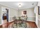 Cozy dining area featuring a round glass table, elegant chairs, and warm lighting at 4702 Sequoia Sw Dr, Lilburn, GA 30047