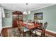 Formal dining room with hardwood floors, traditional furnishings, and a large window at 4702 Sequoia Sw Dr, Lilburn, GA 30047