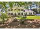 Charming two-story home with a well-manicured lawn, lush landscaping, and a welcoming front porch at 4702 Sequoia Sw Dr, Lilburn, GA 30047